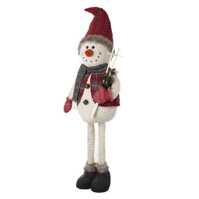 Tall Snowman carrying his Ski's and wearing a Red hat